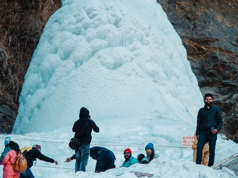 Hikers on green cliff